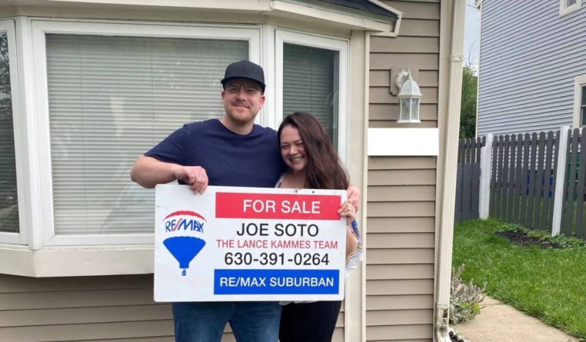 Homeowners with a "for sale" sign